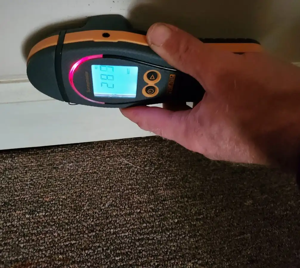 Moisture detection at baseboard during Storm Damage Restoration in Laguna Hills